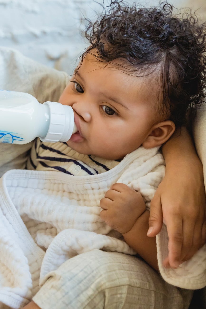 Baby is drinking milk. Image courtesy: pixels.com