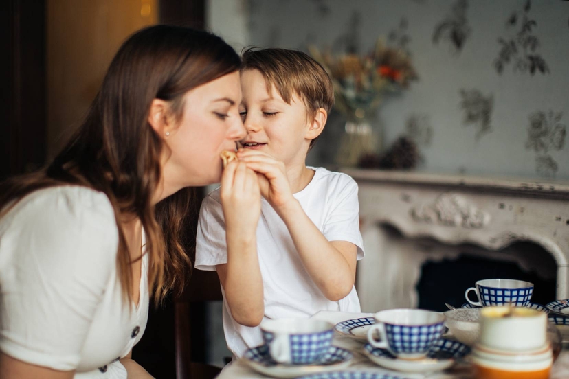 Boy is feeding his mom. Image courtesy: pexels.com